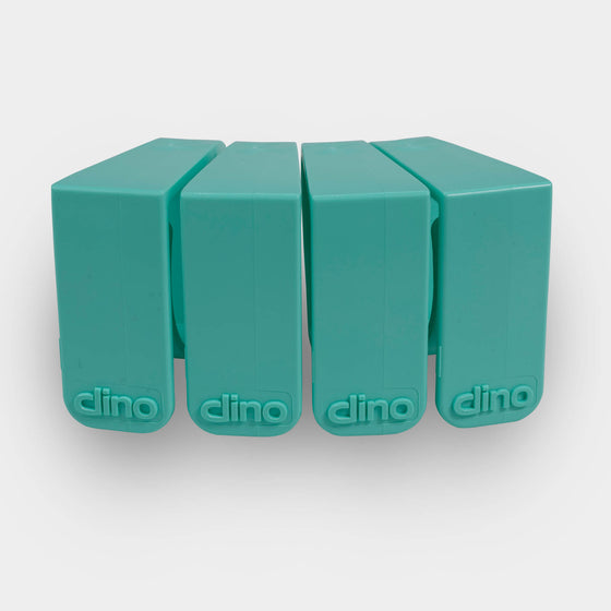 4 green Dino clips in a row desk cable management