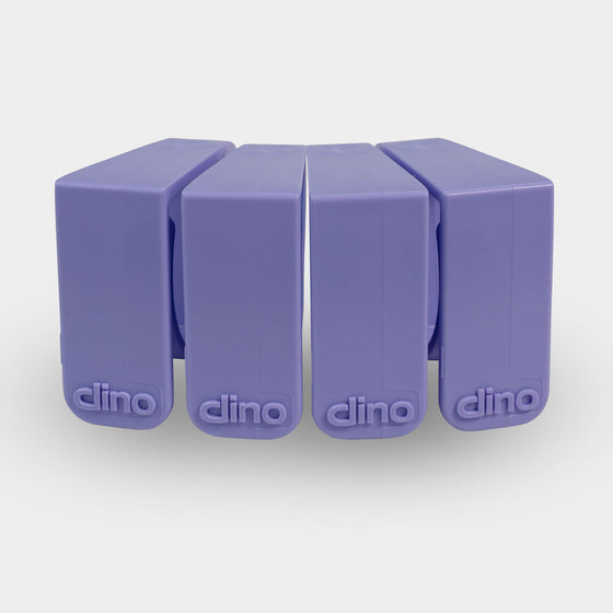 4 purple Dino clips in a row desk cable management